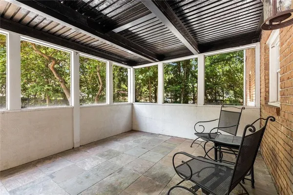a view of a room with furniture and windows