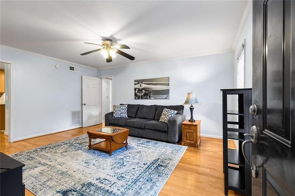 1101 Collier Road Northwest, Unit P2 Atlanta, GA 30318 - Photo 3 of 26 a living room with furniture and a rug