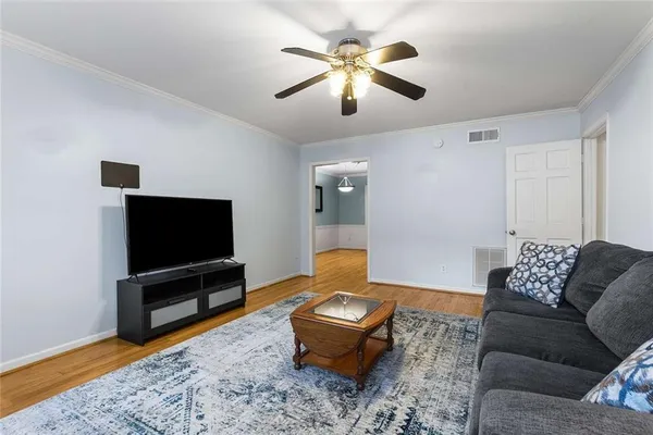 a living room with furniture and a flat screen tv