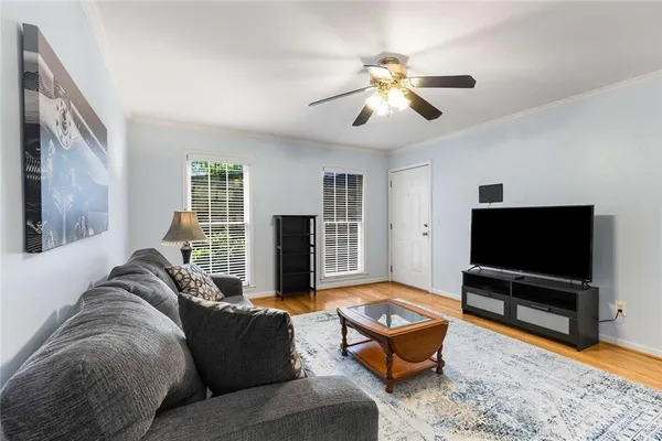 a living room with furniture and a flat screen tv