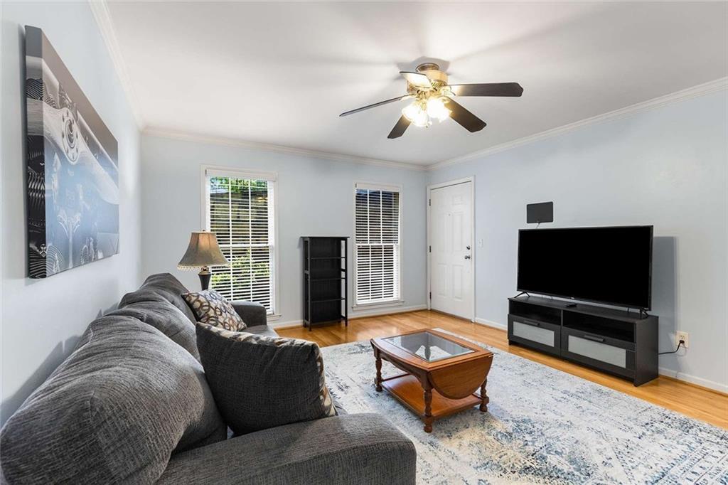 1101 Collier Road Northwest, Unit P2 Atlanta, GA 30318 - Photo 5 of 26 a living room with furniture and a flat screen tv