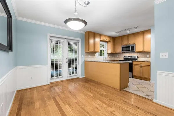 a kitchen with granite countertop a stove a sink and a refrigerator