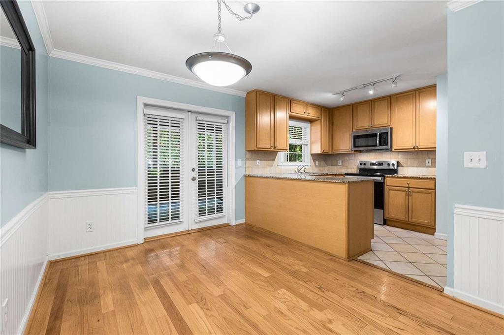 1101 Collier Road Northwest, Unit P2 Atlanta, GA 30318 - Photo 6 of 26 a kitchen with granite countertop a stove a sink and a refrigerator