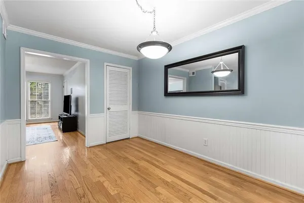 a view of a room with wooden floor and large window