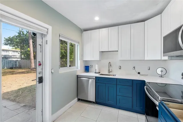 a kitchen with a sink stove top oven and cabinets
