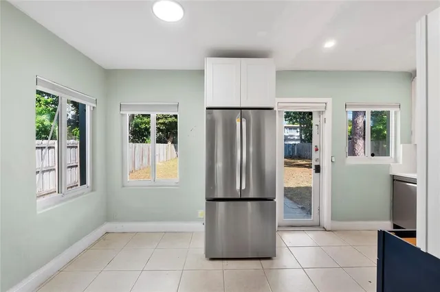 a kitchen with stainless steel appliances a refrigerator and microwave