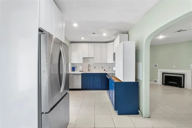 a kitchen with stainless steel appliances a refrigerator and a stove top oven