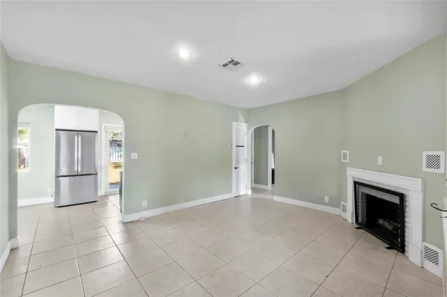 a view of an empty room with a fireplace