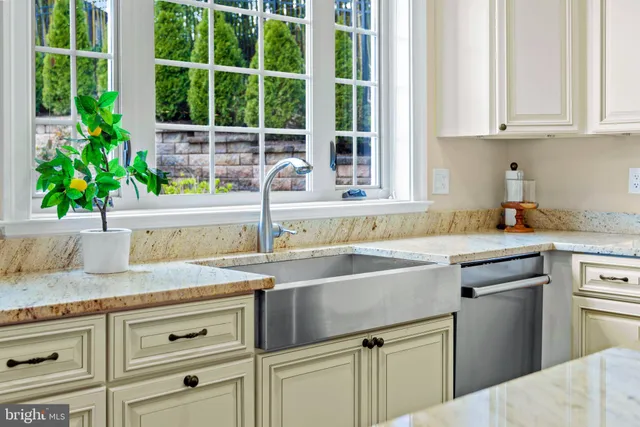 a kitchen with granite countertop a sink and a window