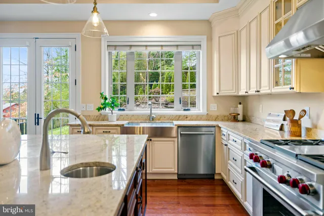 a kitchen with a stove a sink and a wooden cabinets