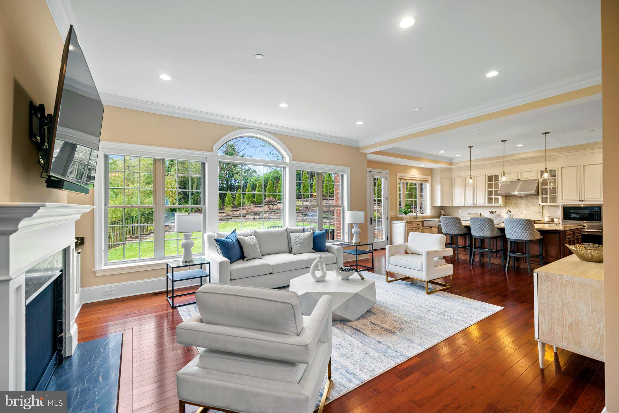 7708 Beech Tree Road Bethesda, MD 20817 - Photo 16 of 55 a living room with fireplace furniture large windows and a flat screen tv