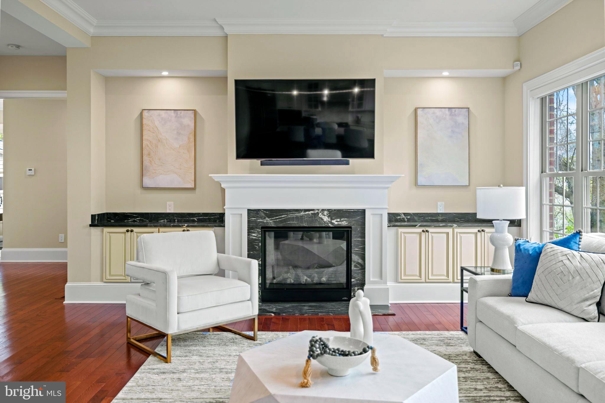 7708 Beech Tree Road Bethesda, MD 20817 - Photo 17 of 55 a living room with furniture and a fireplace