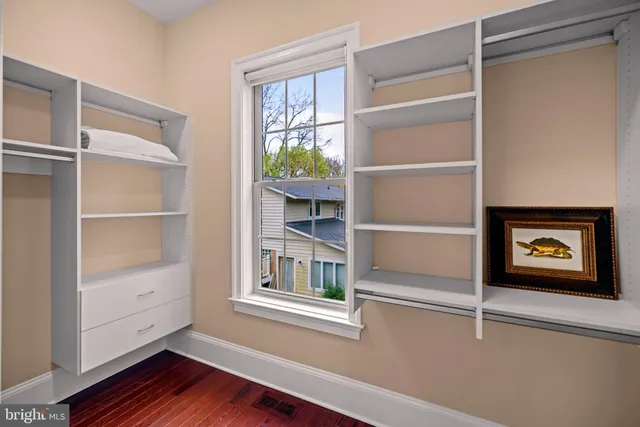 a view of a room with wooden floor and closet