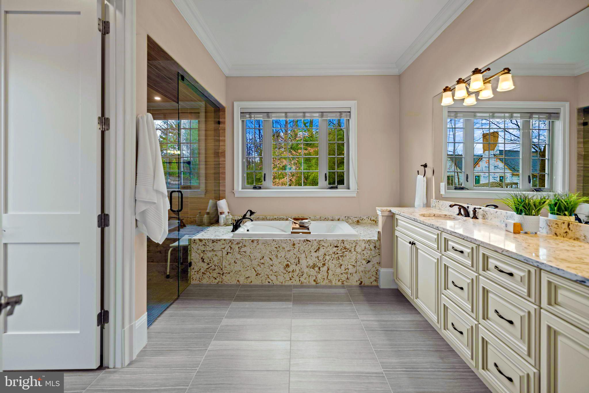 7708 Beech Tree Road Bethesda, MD 20817 - Photo 24 of 55 a bathroom with a tub sink and mirror