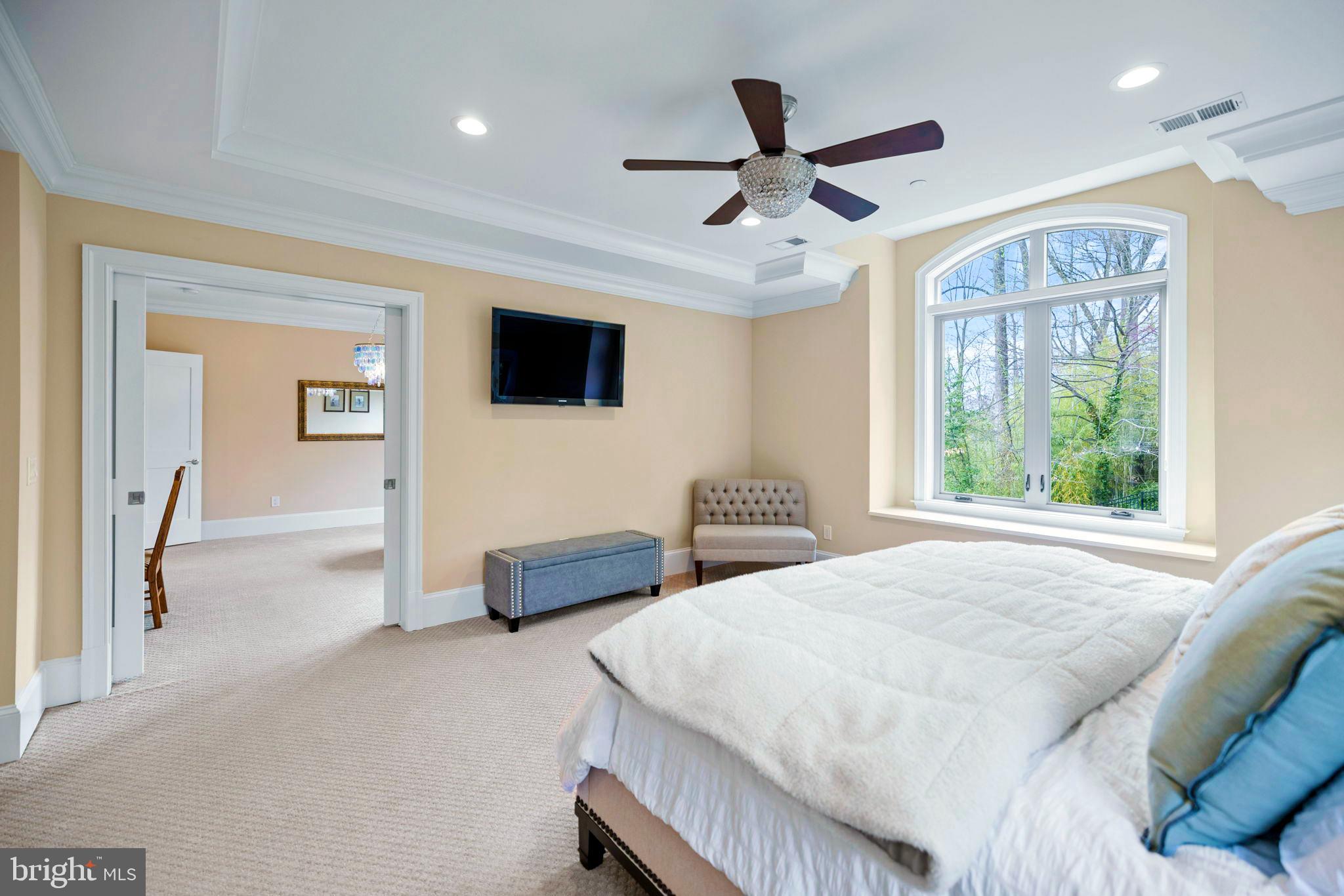 7708 Beech Tree Road Bethesda, MD 20817 - Photo 32 of 55 a bedroom with a large bed and a flat screen tv