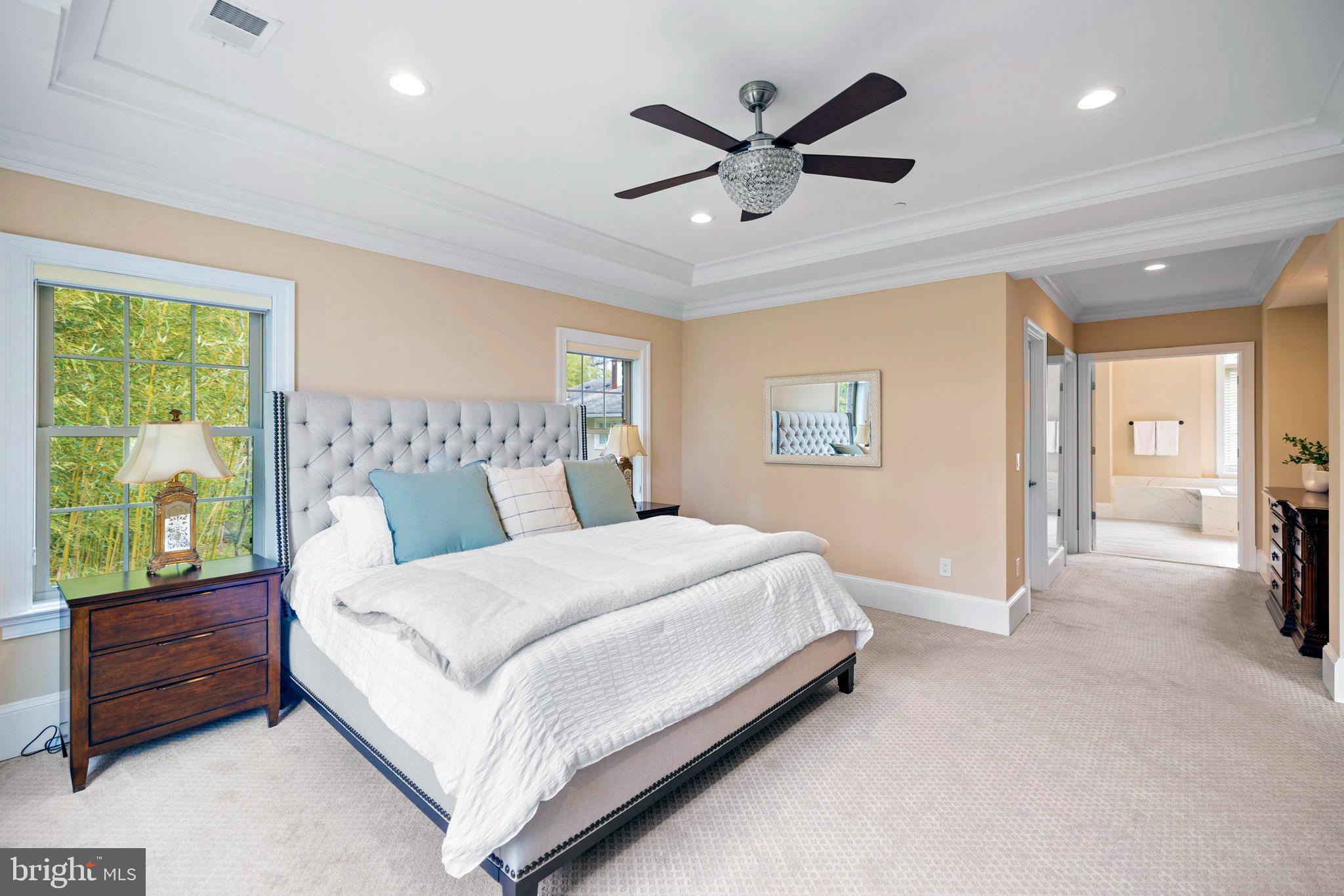 7708 Beech Tree Road Bethesda, MD 20817 - Photo 33 of 55 a bedroom with a large bed and a chandelier