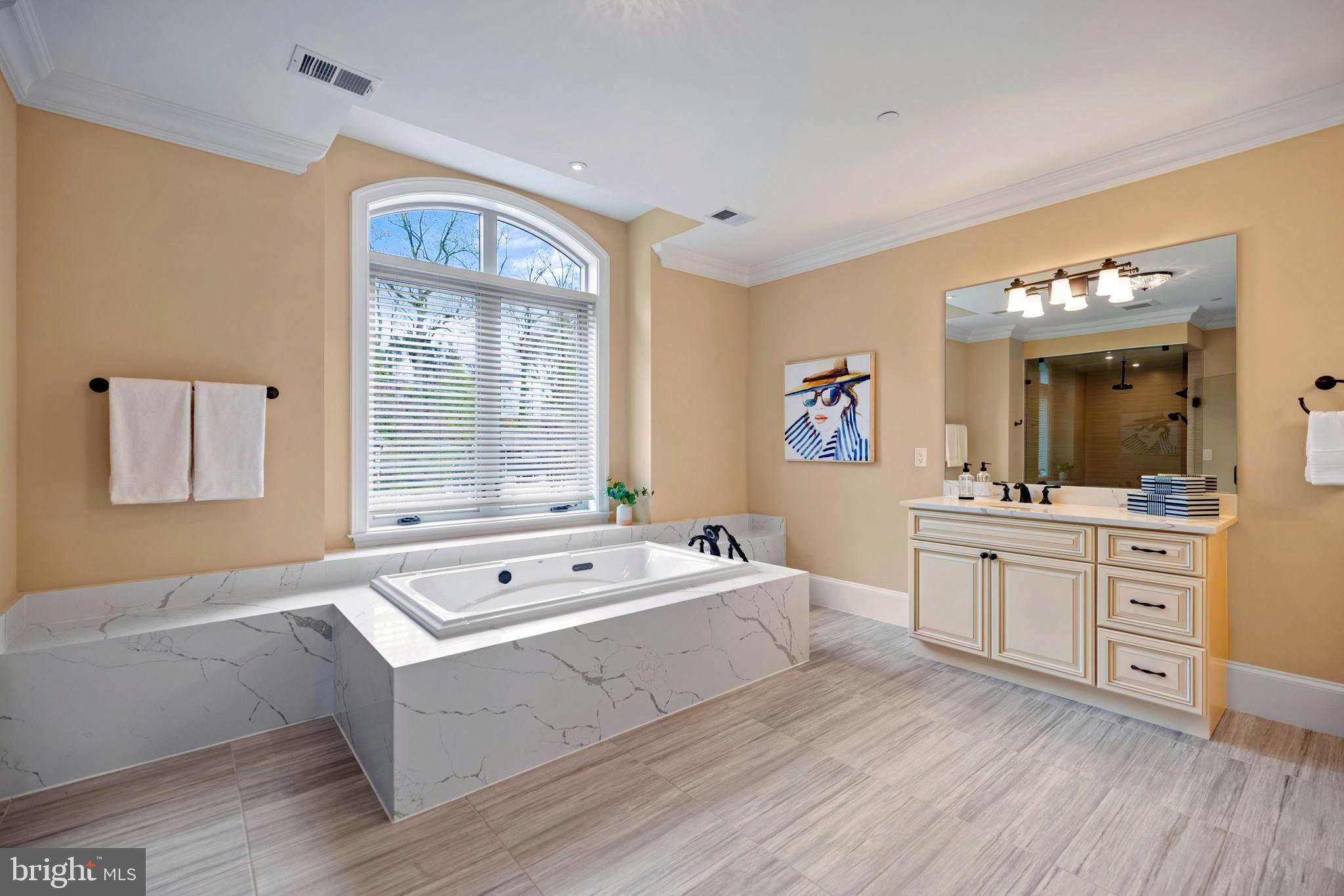 7708 Beech Tree Road Bethesda, MD 20817 - Photo 34 of 55 a spacious bathroom with a tub double vanity sink and a mirror