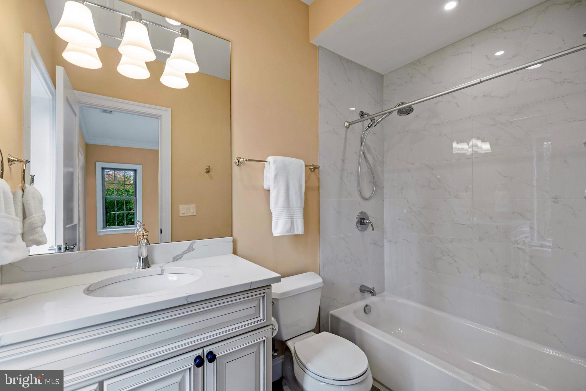 7708 Beech Tree Road Bethesda, MD 20817 - Photo 40 of 55 a bathroom with a granite countertop sink toilet and shower