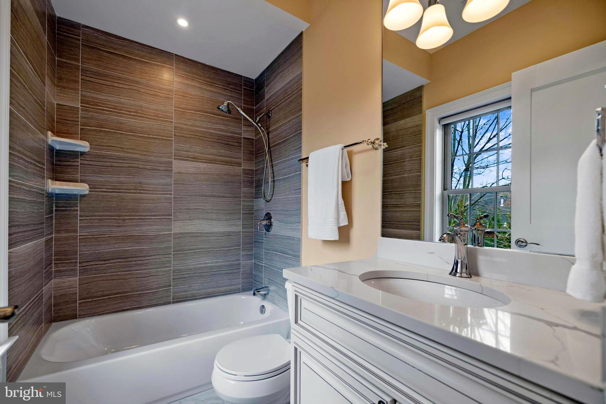 7708 Beech Tree Road Bethesda, MD 20817 - Photo 42 of 55 a bathroom with a granite countertop sink toilet and bathtub