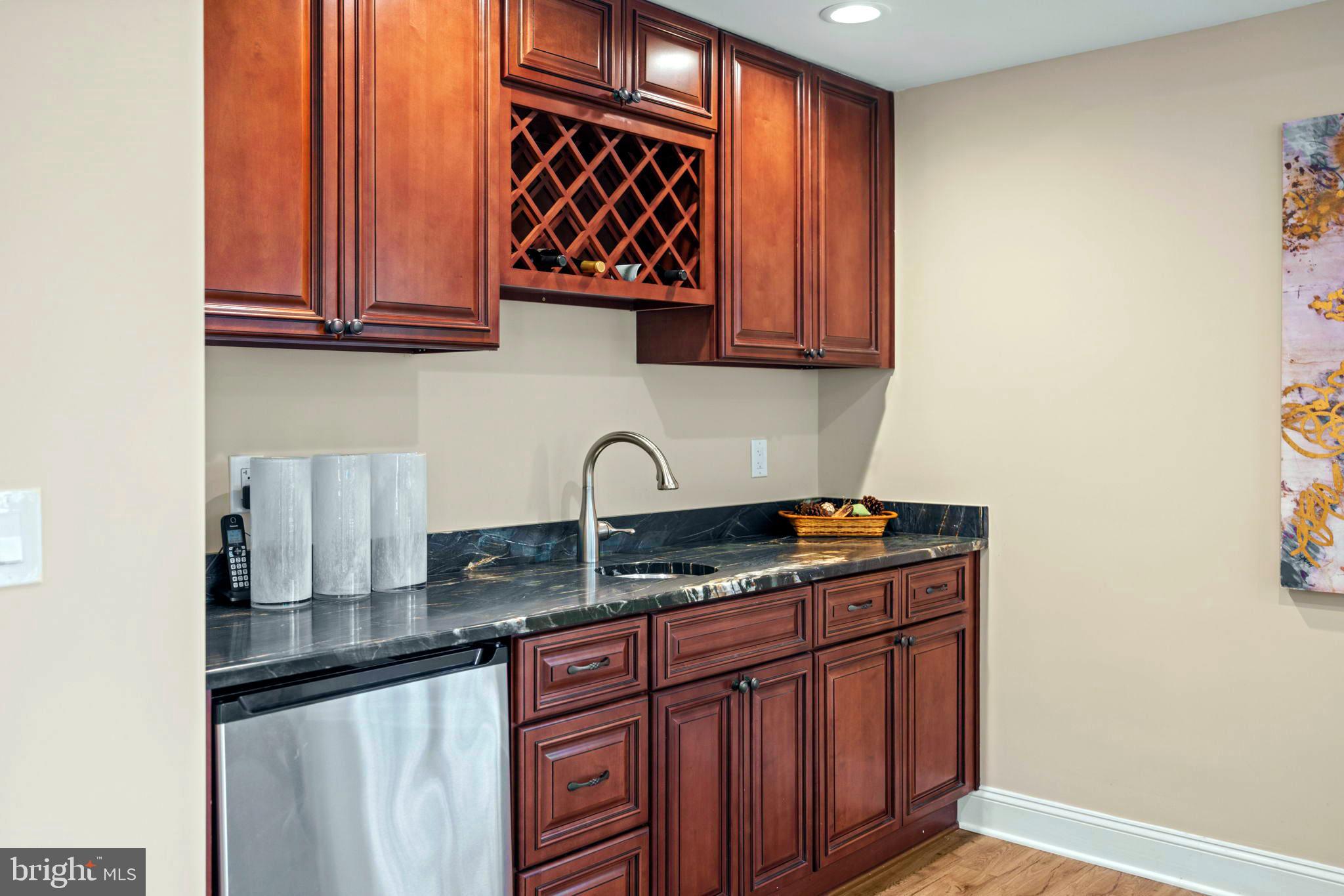7708 Beech Tree Road Bethesda, MD 20817 - Photo 47 of 55 a kitchen with stainless steel appliances granite countertop a sink stove and cabinets