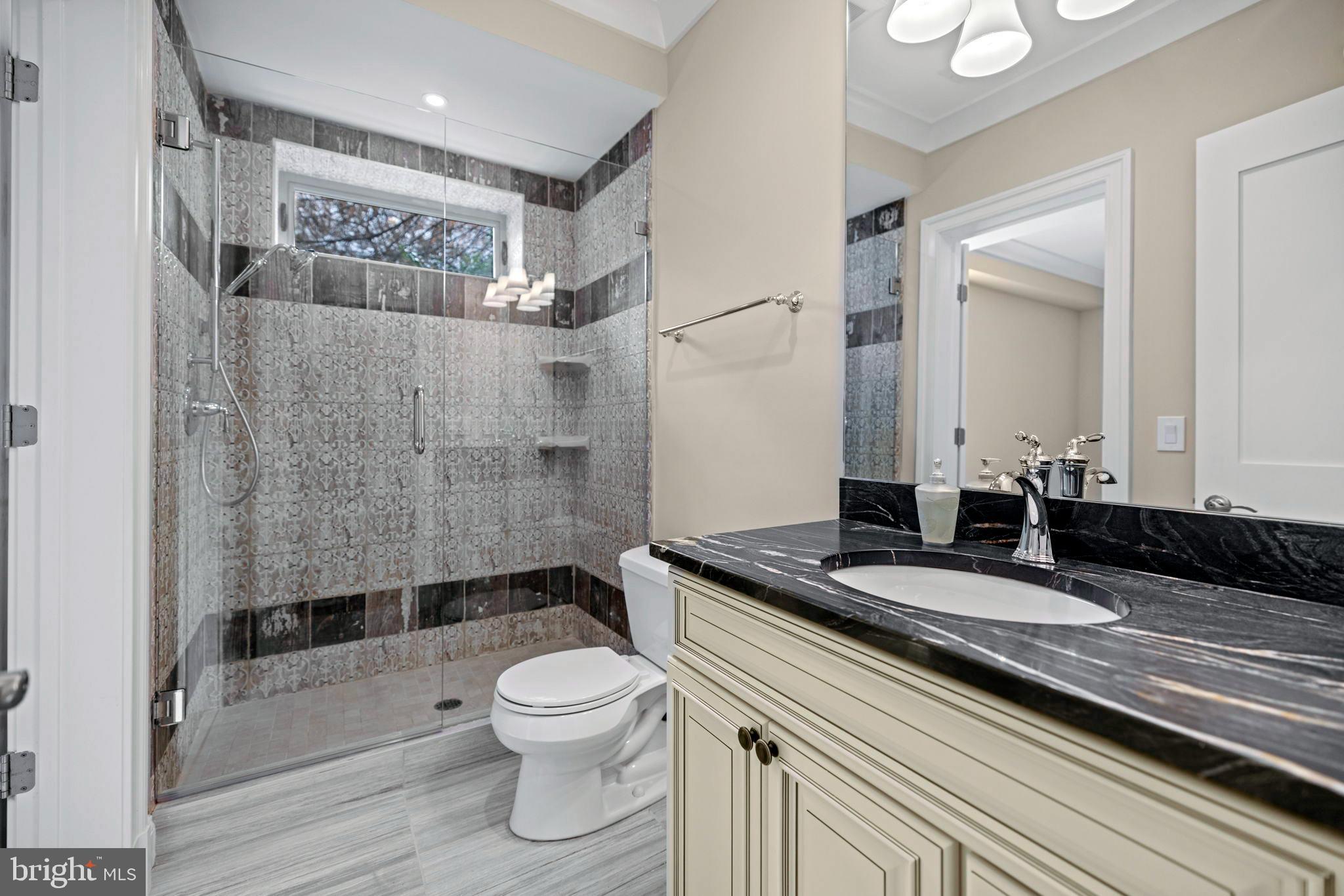 7708 Beech Tree Road Bethesda, MD 20817 - Photo 50 of 55 a bathroom with a granite countertop sink a toilet and shower
