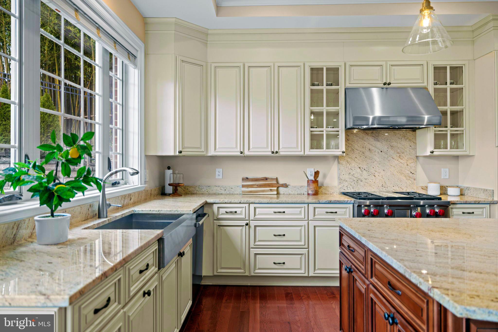 7708 Beech Tree Road Bethesda, MD 20817 - Photo 9 of 55 a kitchen with stainless steel appliances granite countertop a sink stove and cabinets