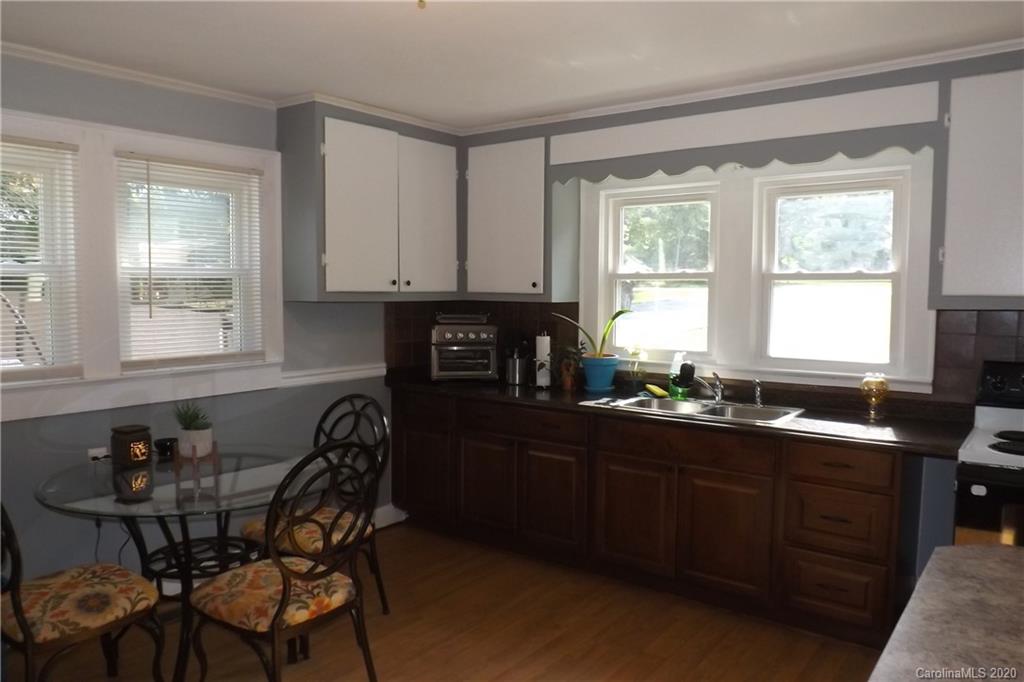 1760 Briggs Road Salisbury, NC 28147 - Photo 11 of 20 a kitchen with granite countertop a sink dining table and chairs