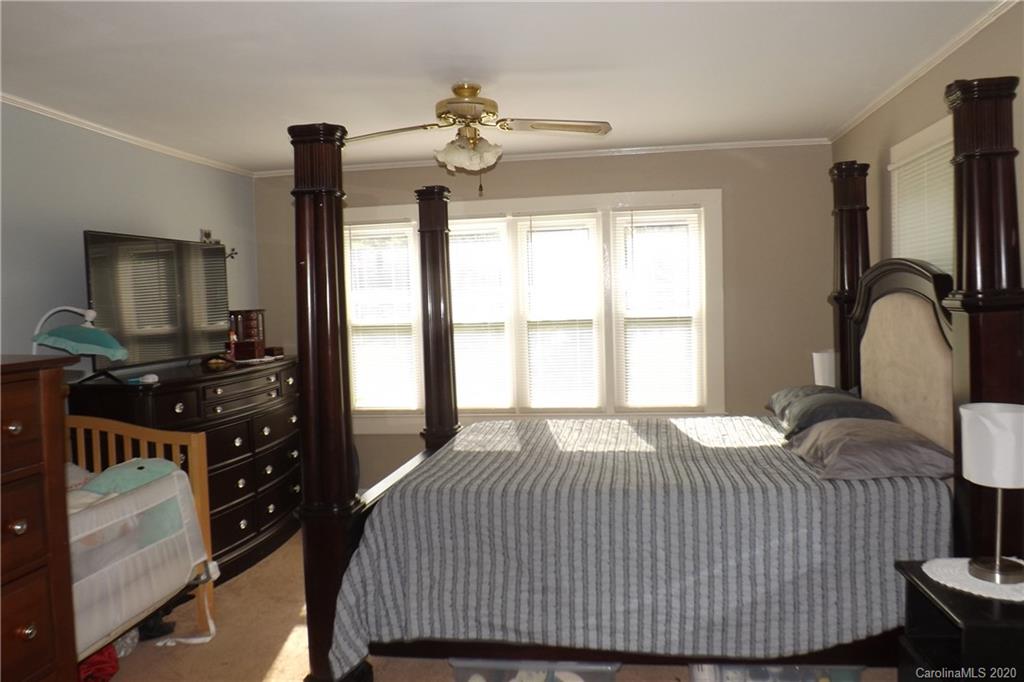 1760 Briggs Road Salisbury, NC 28147 - Photo 17 of 20 a bedroom with a bed and a flat tv screen on dresser