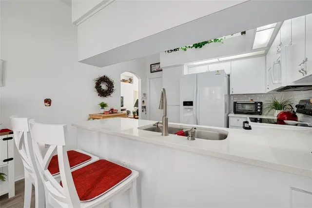 a view of a dining room with furniture a chandelier and wooden floor