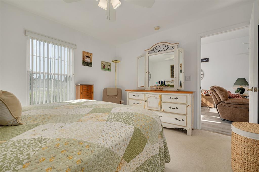 4245 Avanti Circle New Port Richey, FL 34655 - Photo 17 of 28 a bedroom with a bed and a couch