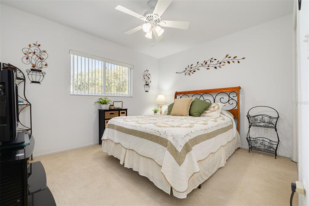 4245 Avanti Circle New Port Richey, FL 34655 - Photo 20 of 28 a bedroom with a bed and a flat tv screen on the dresser