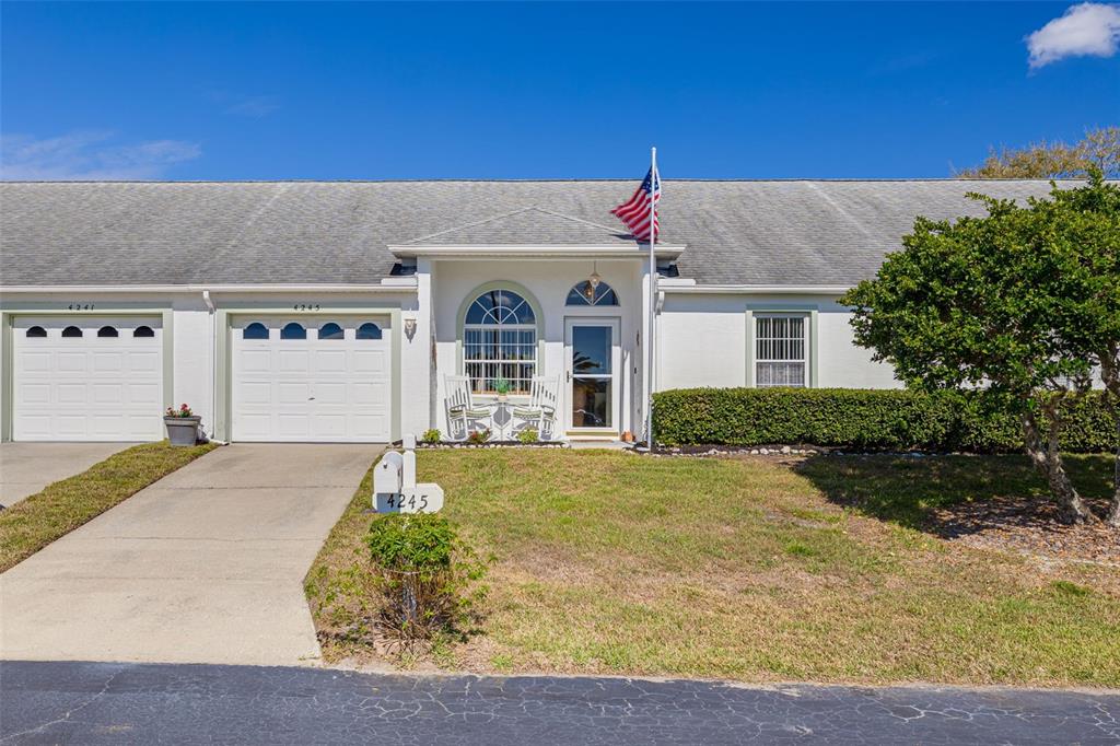 4245 Avanti Circle New Port Richey, FL 34655 - Photo 2 of 28 a front view of a house with garden