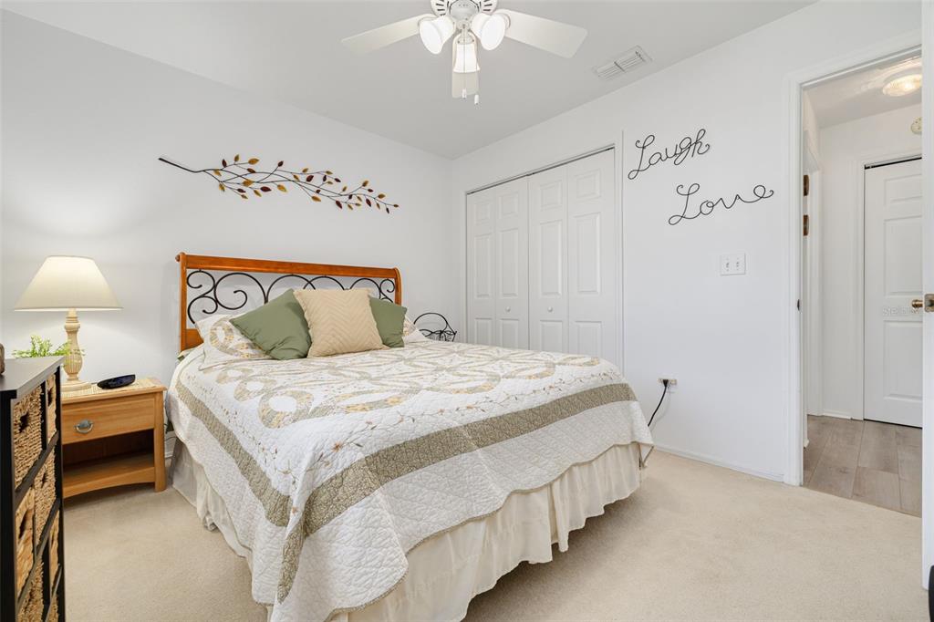 4245 Avanti Circle New Port Richey, FL 34655 - Photo 21 of 28 a bedroom with a bed and a chandelier
