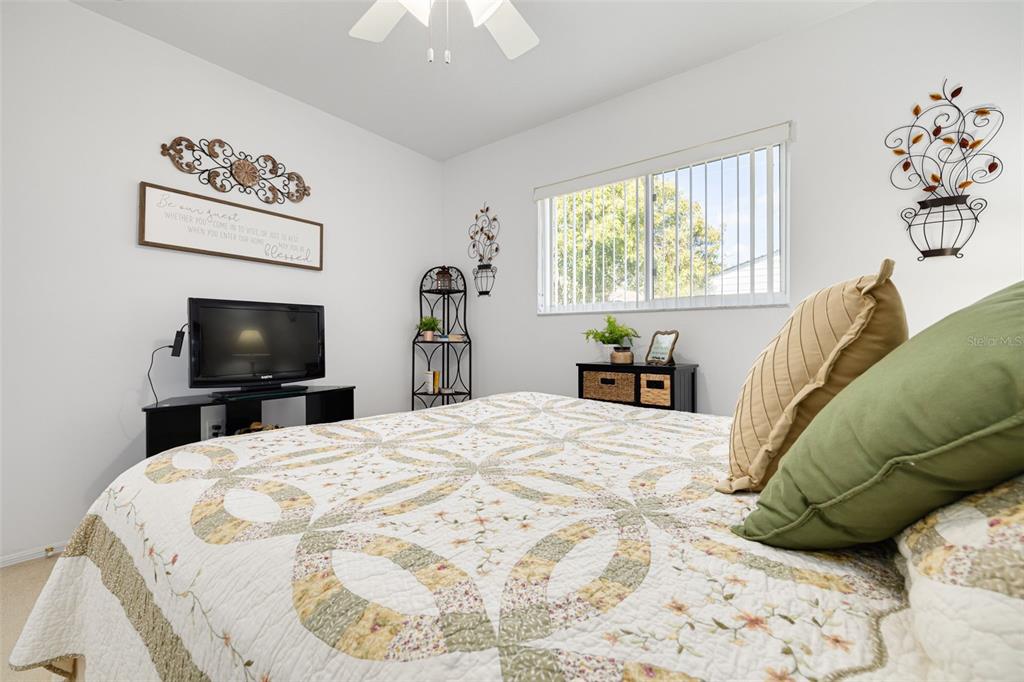 4245 Avanti Circle New Port Richey, FL 34655 - Photo 22 of 28 a bedroom with a bed and a flat screen tv
