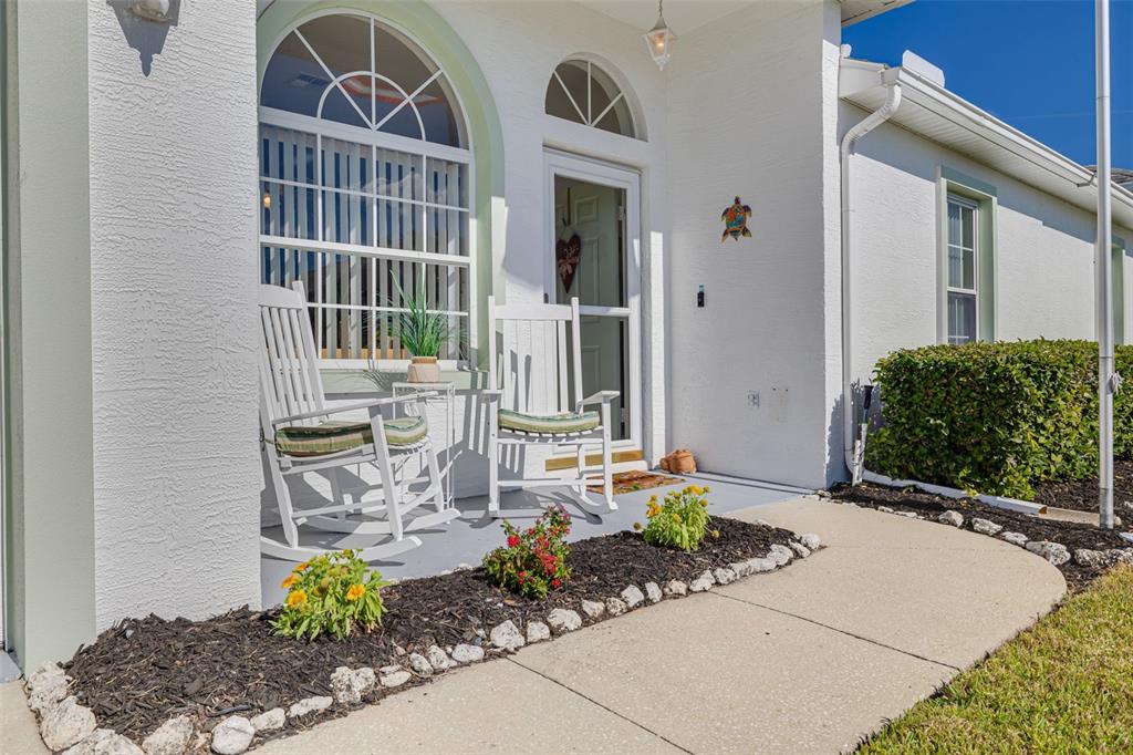 4245 Avanti Circle New Port Richey, FL 34655 - Photo 3 of 28 a front view of a house with a garden