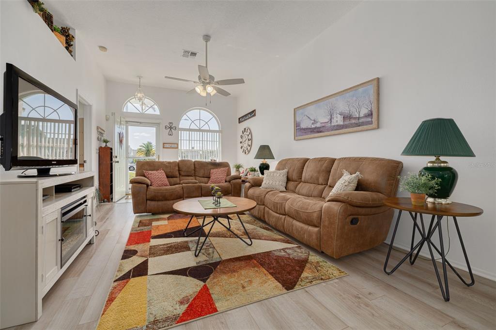 4245 Avanti Circle New Port Richey, FL 34655 - Photo 5 of 28 a living room with furniture a large window and a flat screen tv