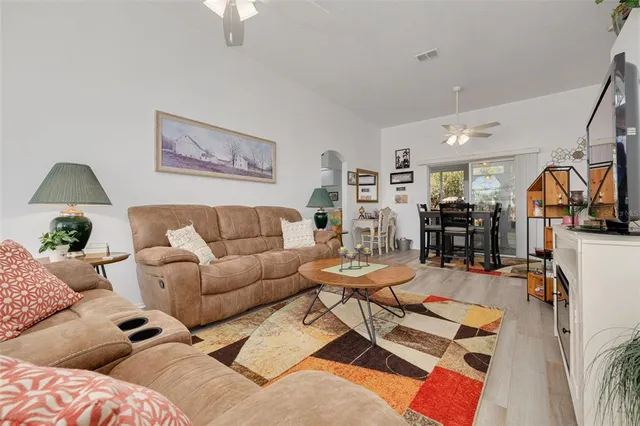 a living room with furniture and wooden floor