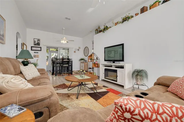 a living room with furniture fireplace and flat screen tv