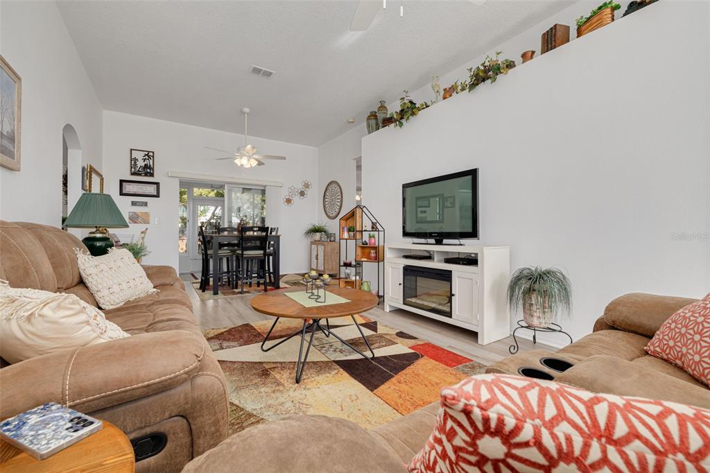 4245 Avanti Circle New Port Richey, FL 34655 - Photo 7 of 28 a living room with furniture fireplace and flat screen tv