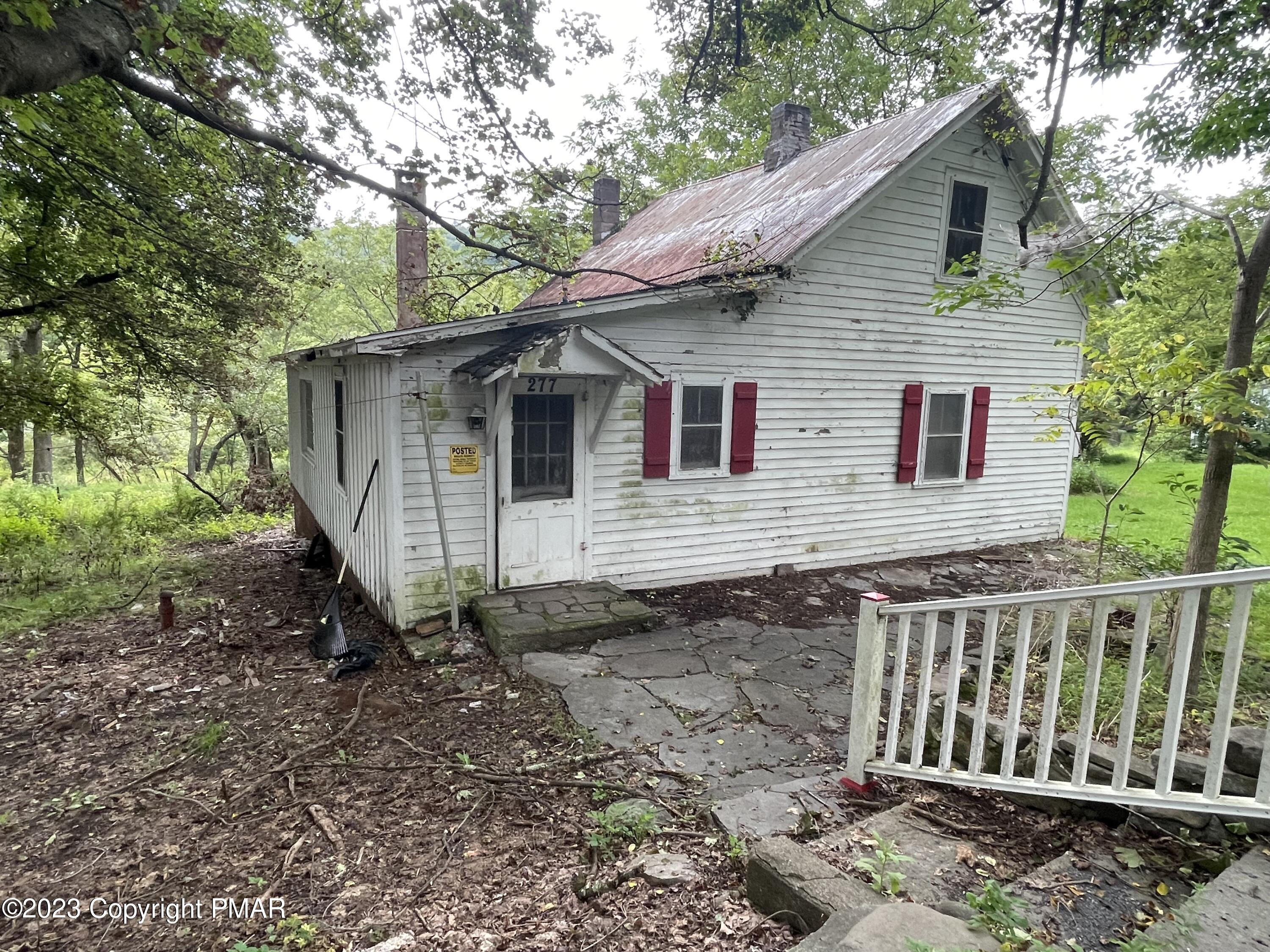 1369 Mutton Hollow Road Stroudsburg, PA 18360 - Photo 1 of 8 a view of a small house with a yard