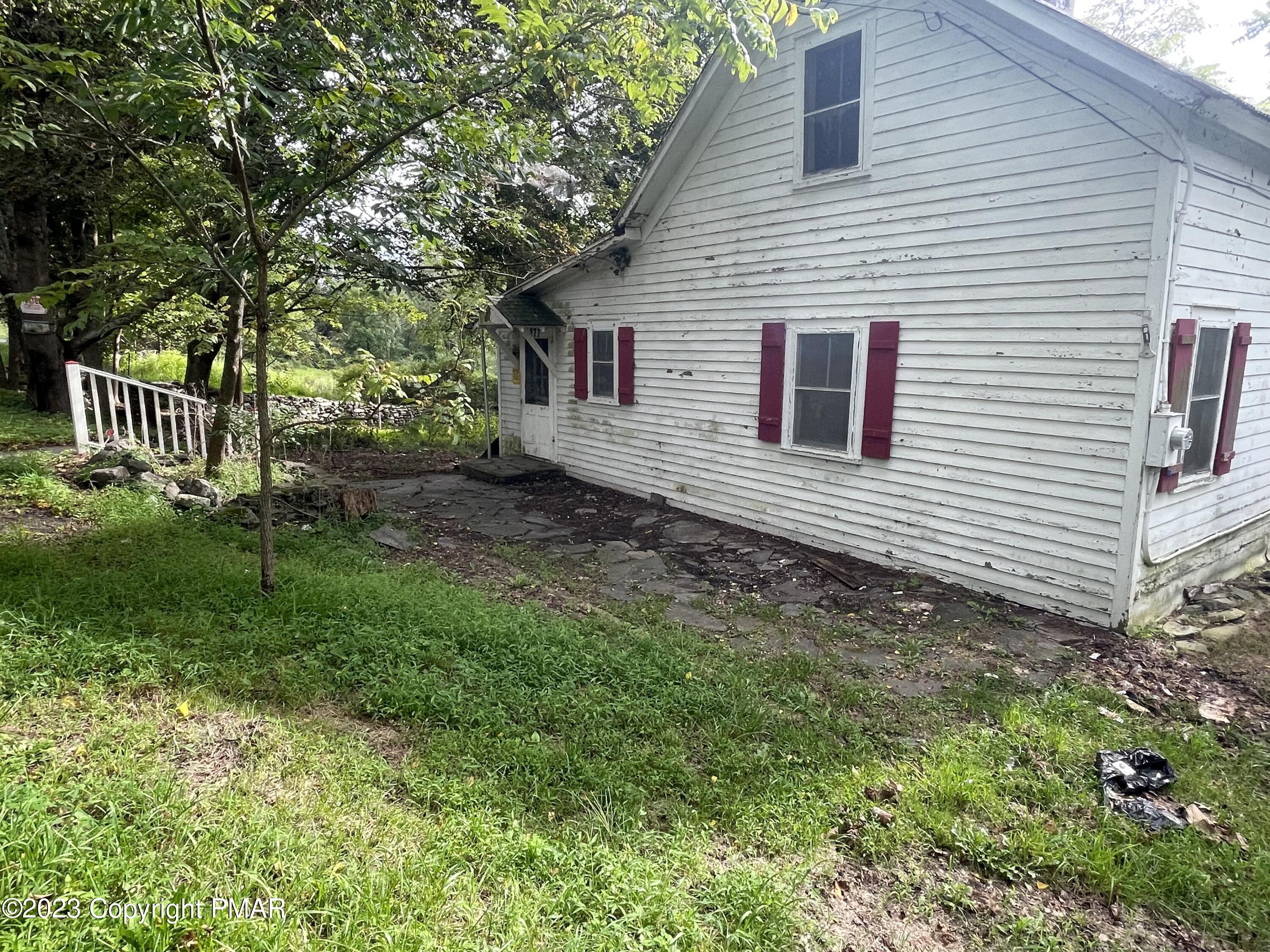 1369 Mutton Hollow Road Stroudsburg, PA 18360 - Photo 2 of 8 a front view of a house with a yard