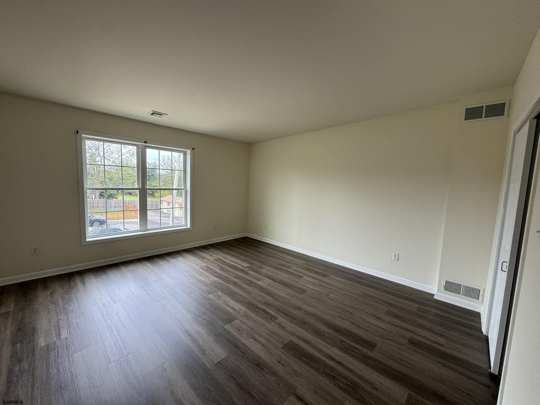 2192 West Avenue, Unit RIGHT SIDE Linwood, NJ 08221 - Photo 12 of 23 an empty room with wooden floor and windows