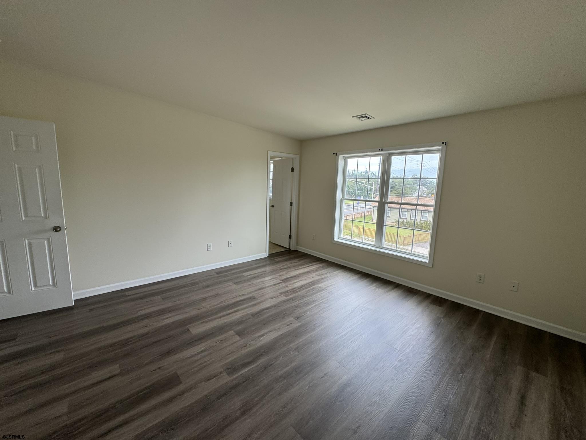 2192 West Avenue, Unit RIGHT SIDE Linwood, NJ 08221 - Photo 13 of 23 an empty room with wooden floor and windows