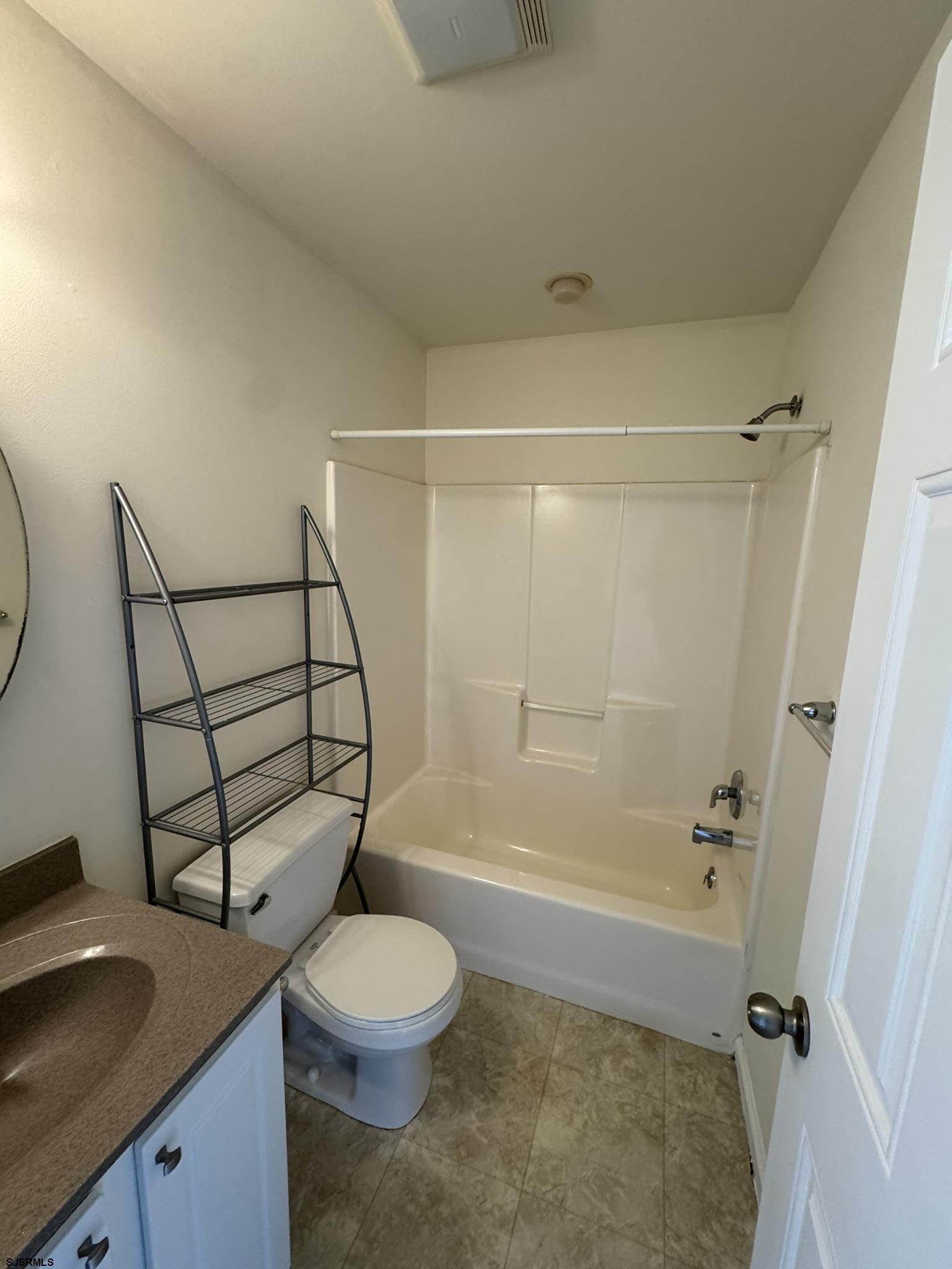 2192 West Avenue, Unit RIGHT SIDE Linwood, NJ 08221 - Photo 20 of 23 a bathroom with a granite countertop sink toilet a mirror and shower