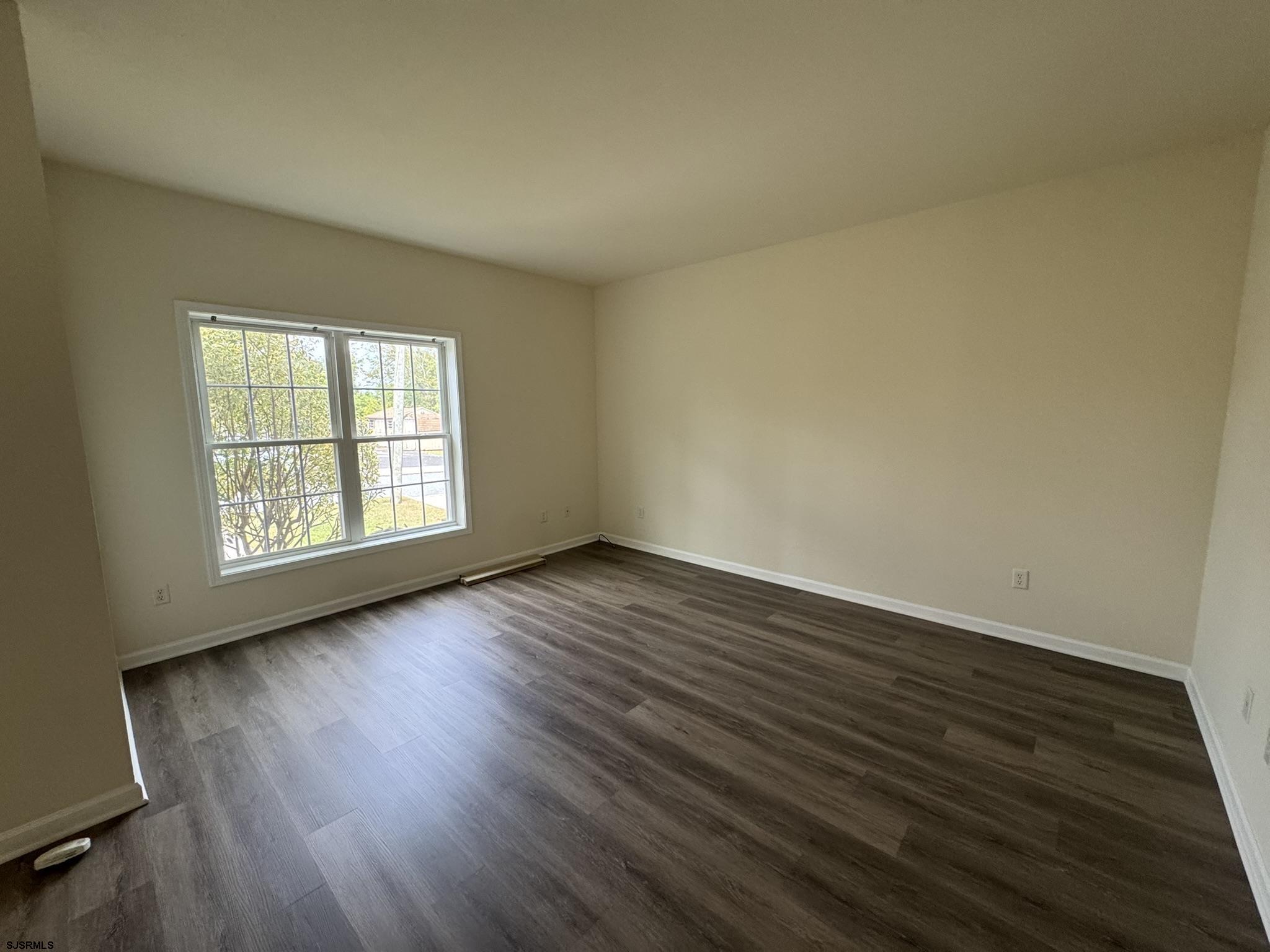 2192 West Avenue, Unit RIGHT SIDE Linwood, NJ 08221 - Photo 4 of 23 an empty room with wooden floor and windows