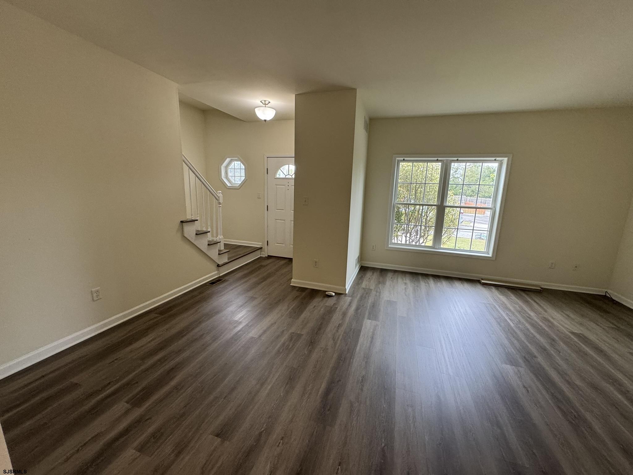 2192 West Avenue, Unit RIGHT SIDE Linwood, NJ 08221 - Photo 6 of 23 an empty room with wooden floor and windows