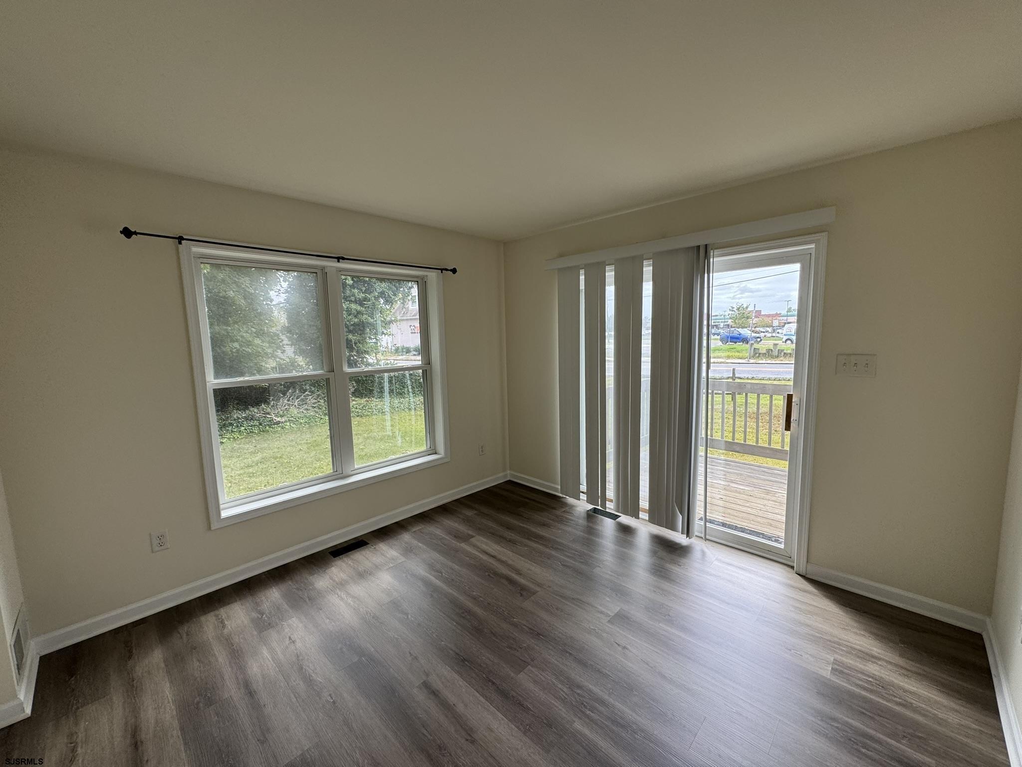 2192 West Avenue, Unit RIGHT SIDE Linwood, NJ 08221 - Photo 7 of 23 an empty room with wooden floor and windows