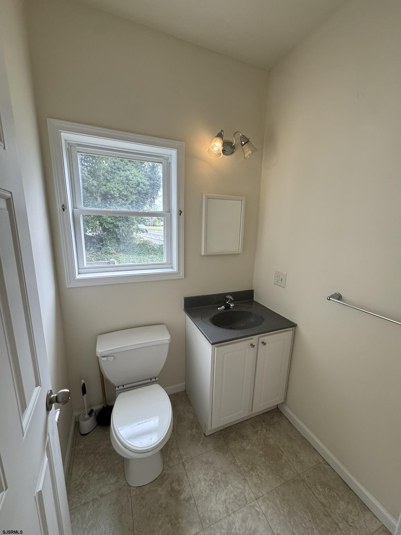 2192 West Avenue, Unit RIGHT SIDE Linwood, NJ 08221 - Photo 9 of 23 a bathroom with a toilet sink and a window