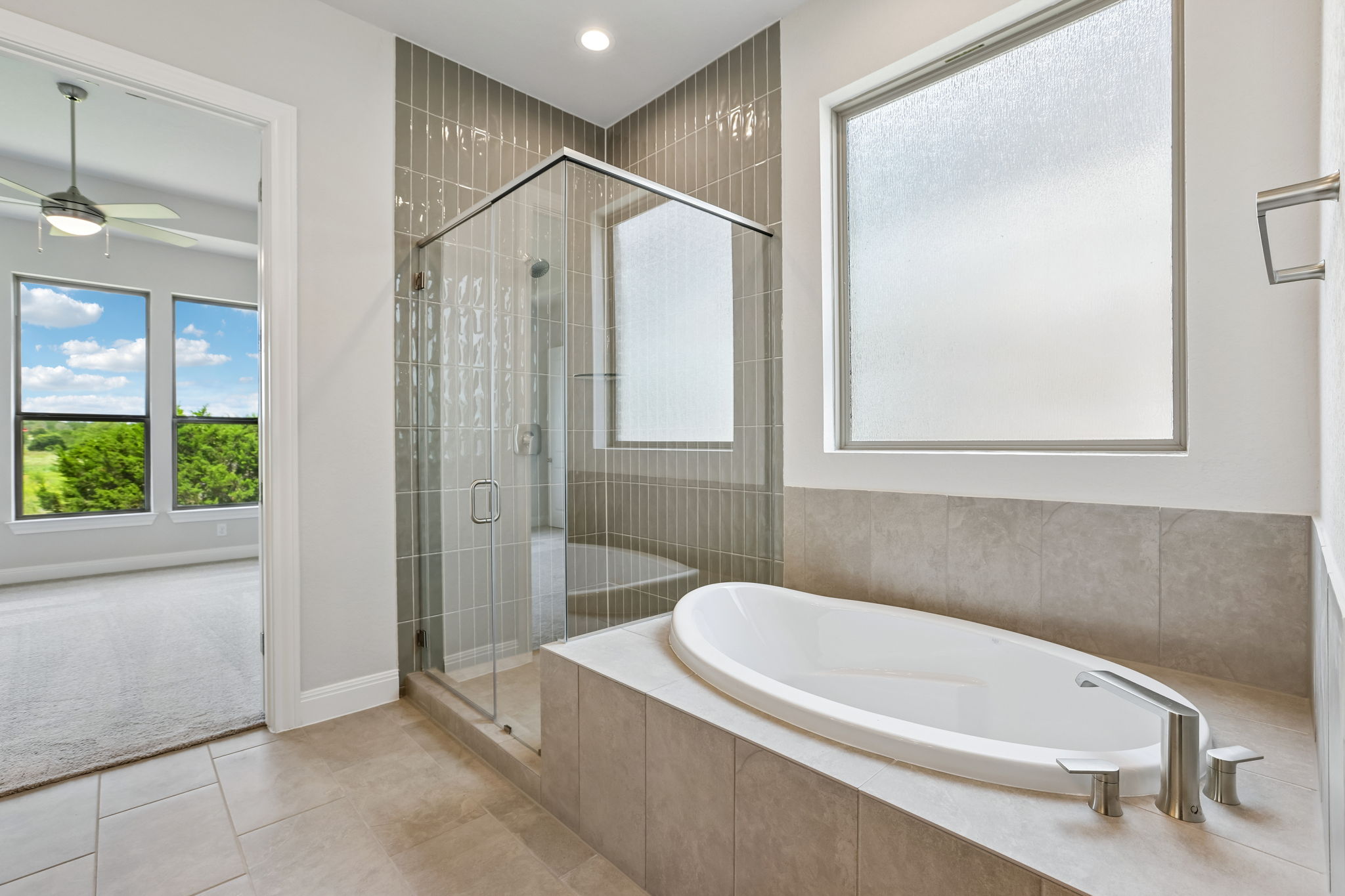 214 Prickly Poppy Loop Kyle, TX 78640 - Photo 23 of 38 a bathroom with a tub a sink and a shower