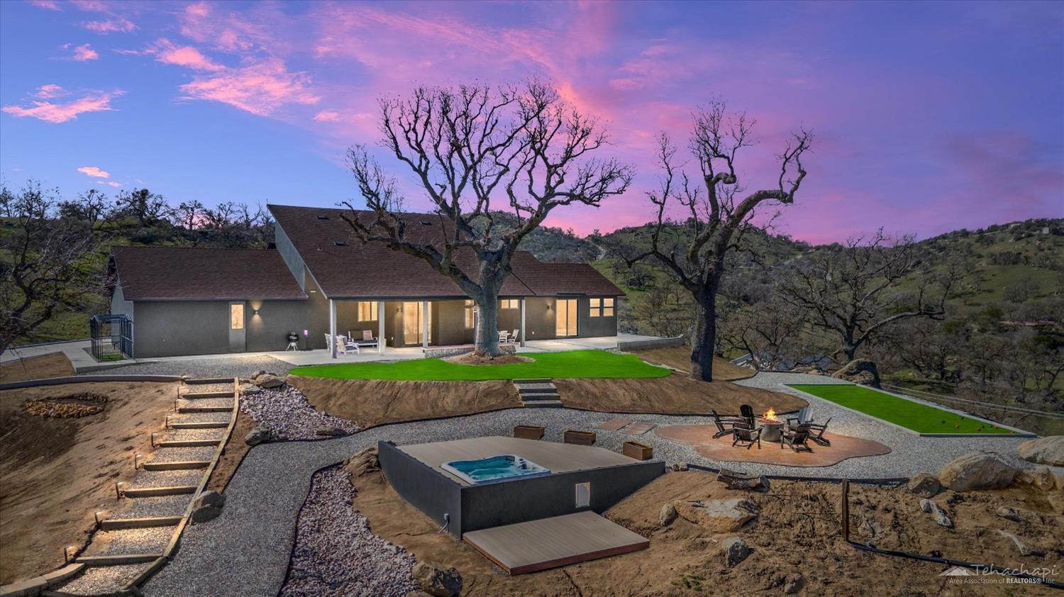 28901 Augusta Way Tehachapi, CA 93561 - Photo 1 of 65 a front view of a house with garden and trees